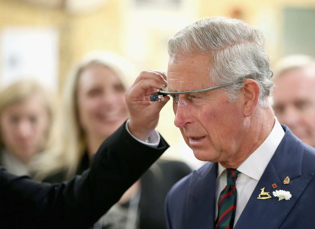 WINNIPEG, MB - MAY 21: Prince Charles, Prince of Wales tries on 'Google Glass' spectacles as he visits 'Innovation Alley' on May 21, 2014 in Winnipeg, Canada. The Prince of Wales and Duchess of Cornwall are on a four day visit to Canada. (Photo by Chris Jackson/Getty Images)