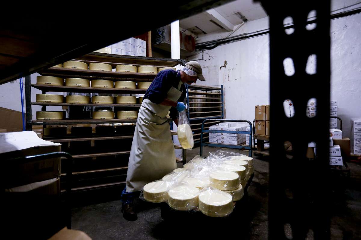 James Hinchman, packages California Daisy Cheddar rounds which are stored on wooden shelves during processing at the Vella Cheese Co. in Sonoma, Calif. as seen on Tuesday June 10, 2014. The FDA has just issued a statement saying that aging cheeses on wooden boards is "unsanitary." This could affect the entire artisanal cheese industry in the US. Vella Cheese in Sonoma has been aging its dry jack on wooden racks for 81 years, without a single incidence of bacterial contamination.