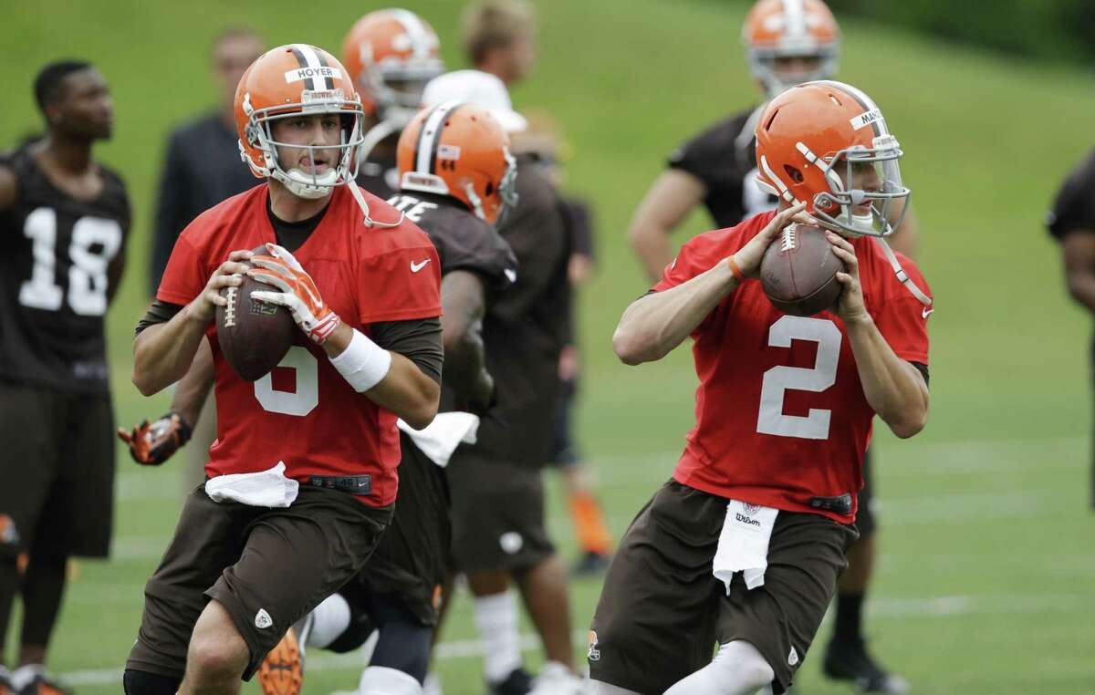 Browns starting QB Brian Hoyer (left) and backup Johnny Manziel go through drills during Tuesday's minicamp. Manziel is back at practice after partying in Texas, which didn't bother coach Mike Pettine.