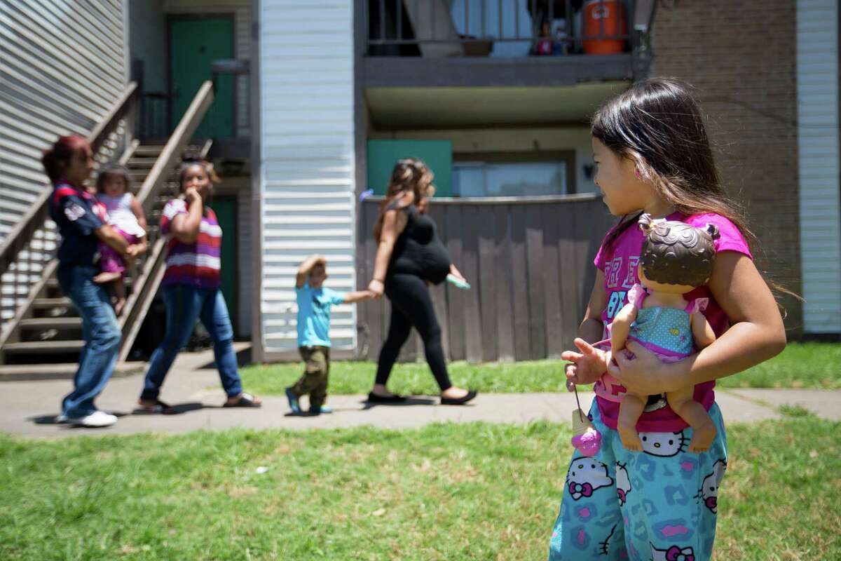 Shadow Melendez, 6, ﻿stands outside the house where Ayahna Comb's body was found June 9 in her mother's refrigerator.