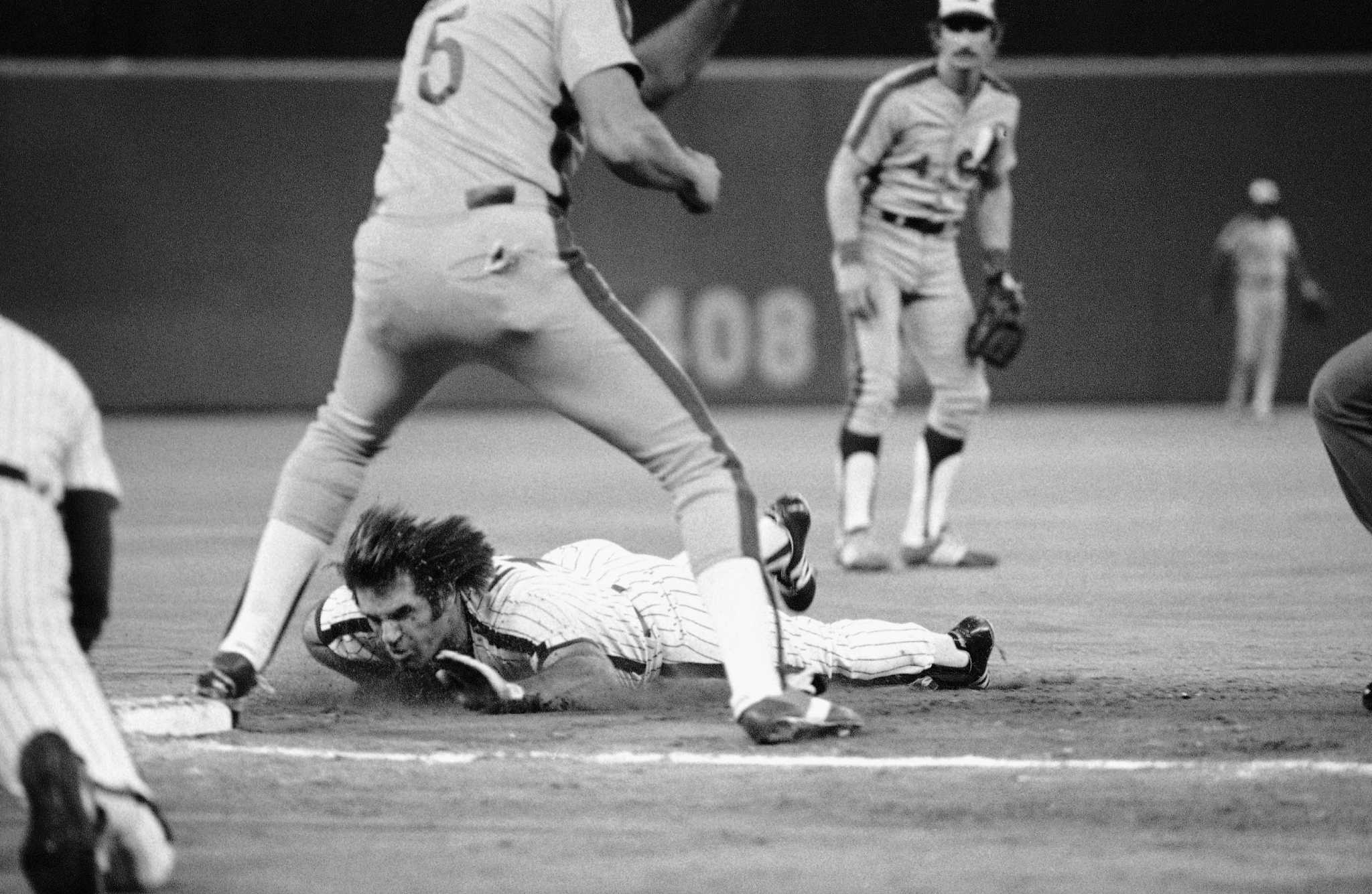 Miami Marlins Jose Reyes motions his team mates after sliding into second  base against the New York Yankees at the new Miami Marlins Ball Park in the  second exhibition game April 2