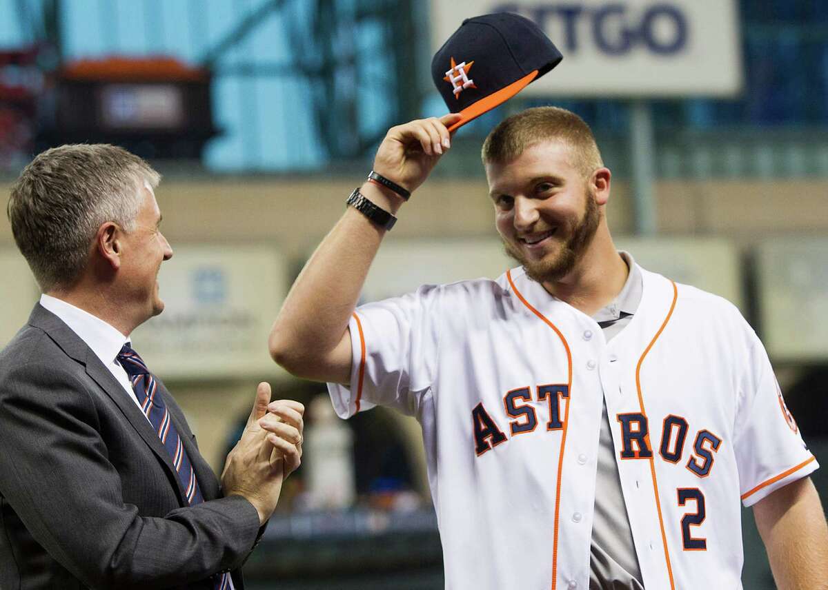 Freshly signed draft pick A.J. Reed shows off his new gear while being introduced Wednesday at Minute Maid Park.