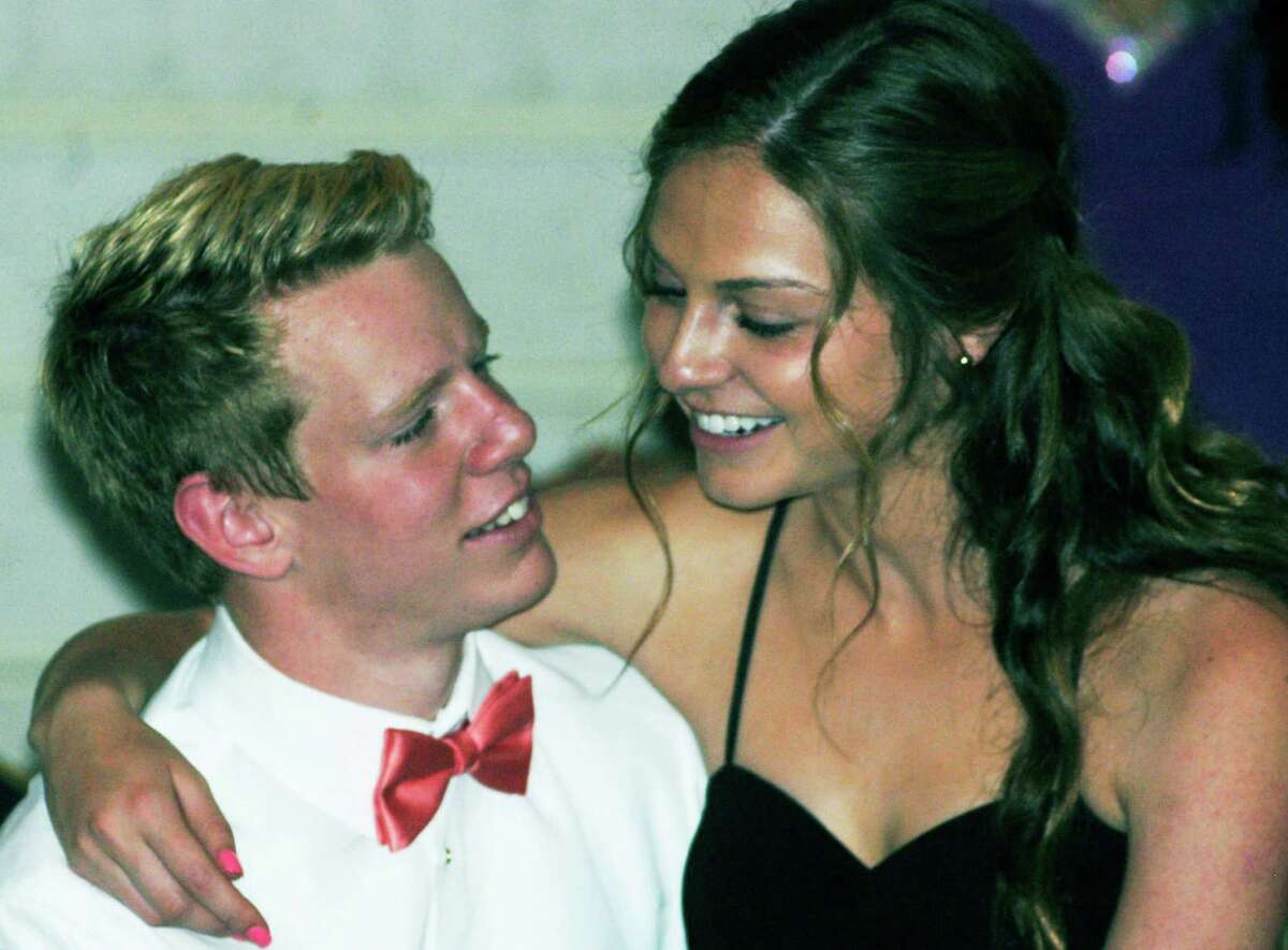 Freddie Pitcher and Taylor Weston find a break from dancing to be just the right idea during the Shepaug Valley High School Prom, May 24, 2014 at the Crowne Plaza in Southbury.