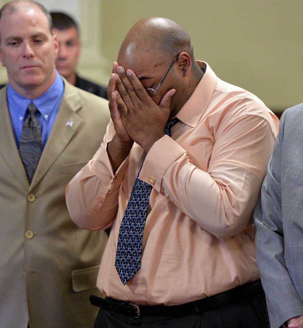 Adrian Thomas, flanked by his defense team, holds his hands to his head after being acquitted of second-degree murder in the death of his infant son, Matthew Dante Thomas,Thursday afternoon, June 12, 2014, at the Rensselaer County Courthouse in Troy, N.Y. (Skip Dickstein / Times Union)