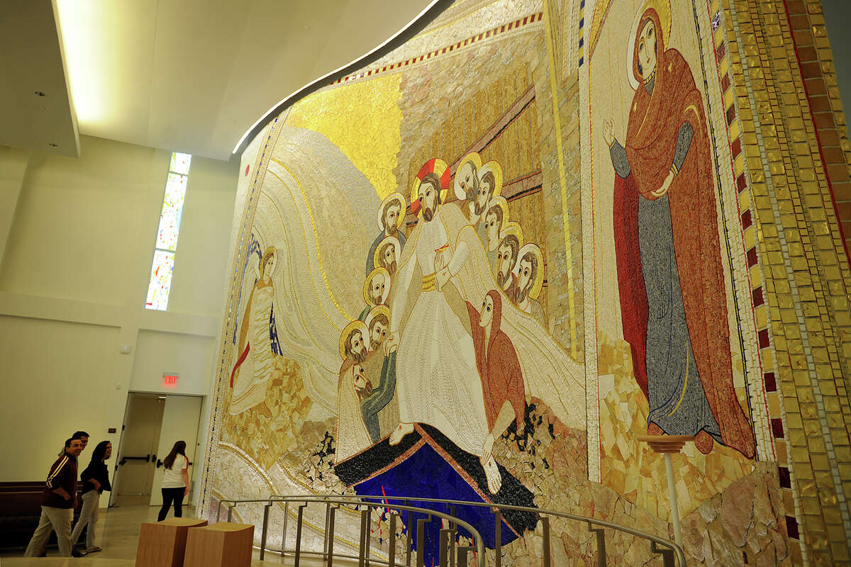A tour group of potential students and their parents visits the main chapel featuring a backdrop of hand-laid Italian mosaic tile at Sacred Heart University's campus in Fairfield, Conn. on Sunday, June 12, 2014.