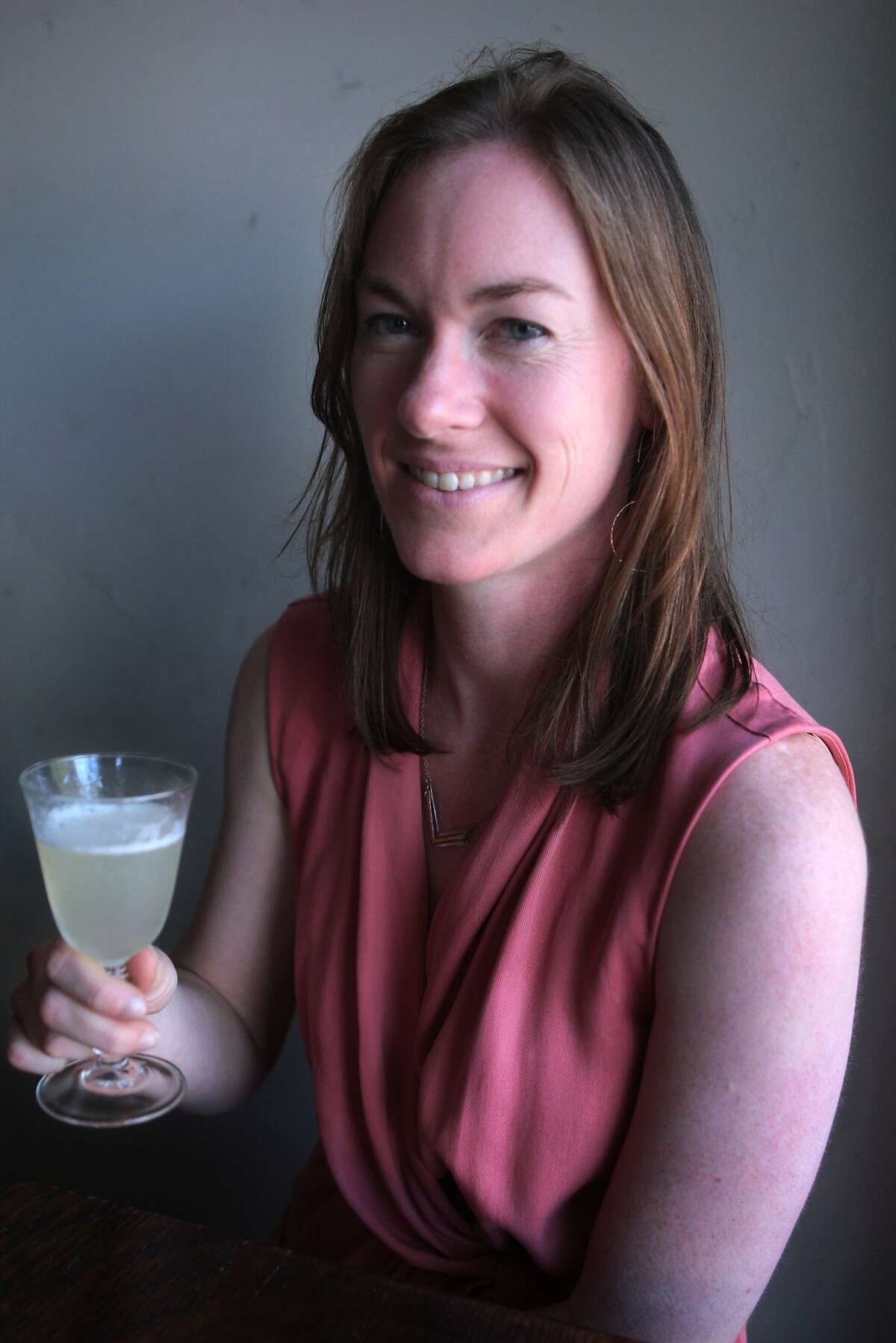 Historian Shanna Farrell holds a Pisco Punch, a cocktail invented in San Francisco in the 19th century at the East Bay Spice Company bar and restaurant in Berkeley, Calif. on Monday, June 9, 2014. Farrell is doing an oral history project on West Coast cocktails for the Regional Oral History Office at UC Berkeley's Bancroft Library.