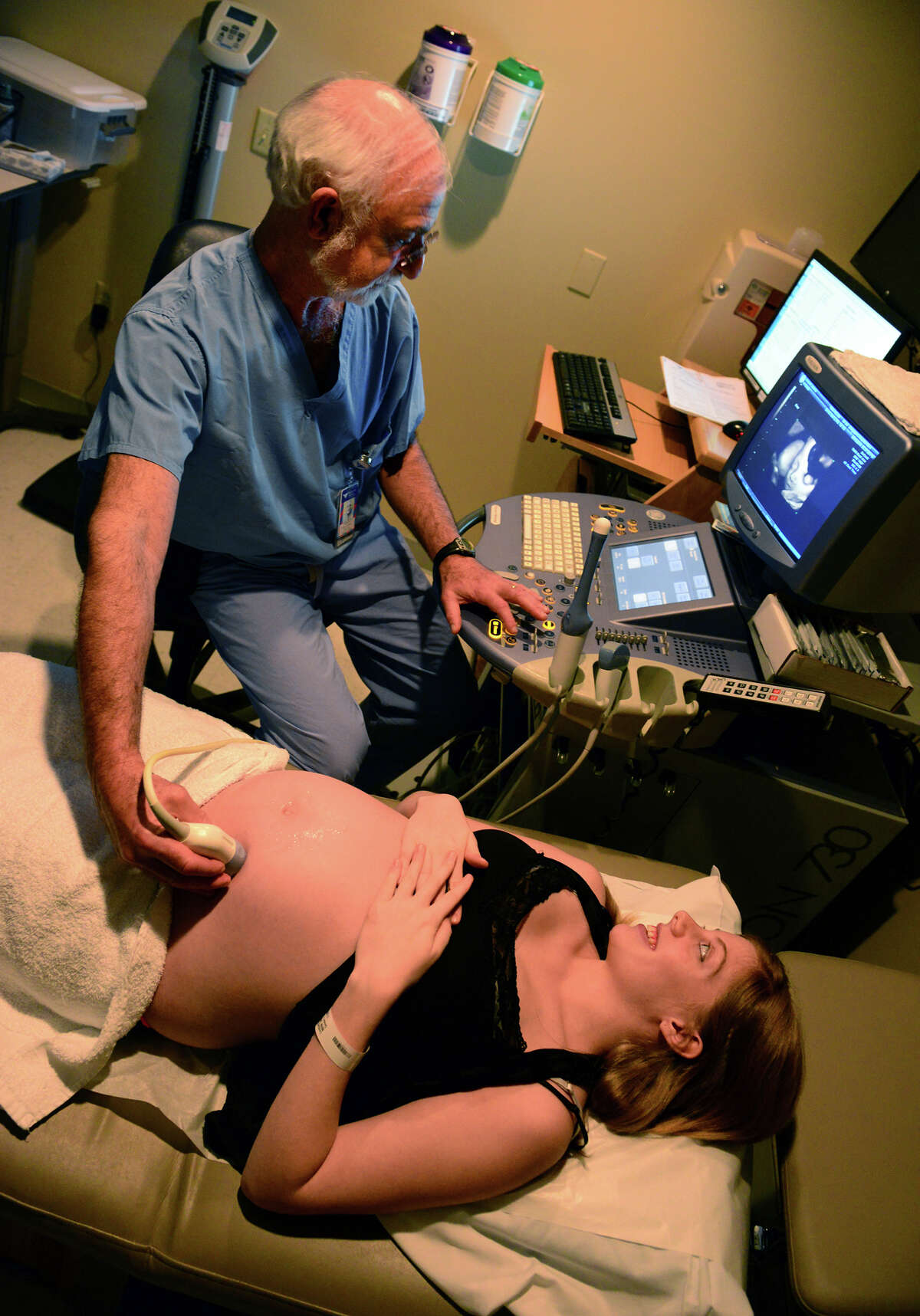 Dr. Robert Stiller performs an ultrasound on his patient Toni Lombardi, of Fairfield, at Bridgeport Hospital in Bridgeport, Conn. on Thursday June 12, 2014. Traditionaly during pregnancy, a needle has been used to draw fluid from the womb to test for birth defects, in a procedure called amniocentesis. But now a simple blood test can be done instead to check for the same defects.