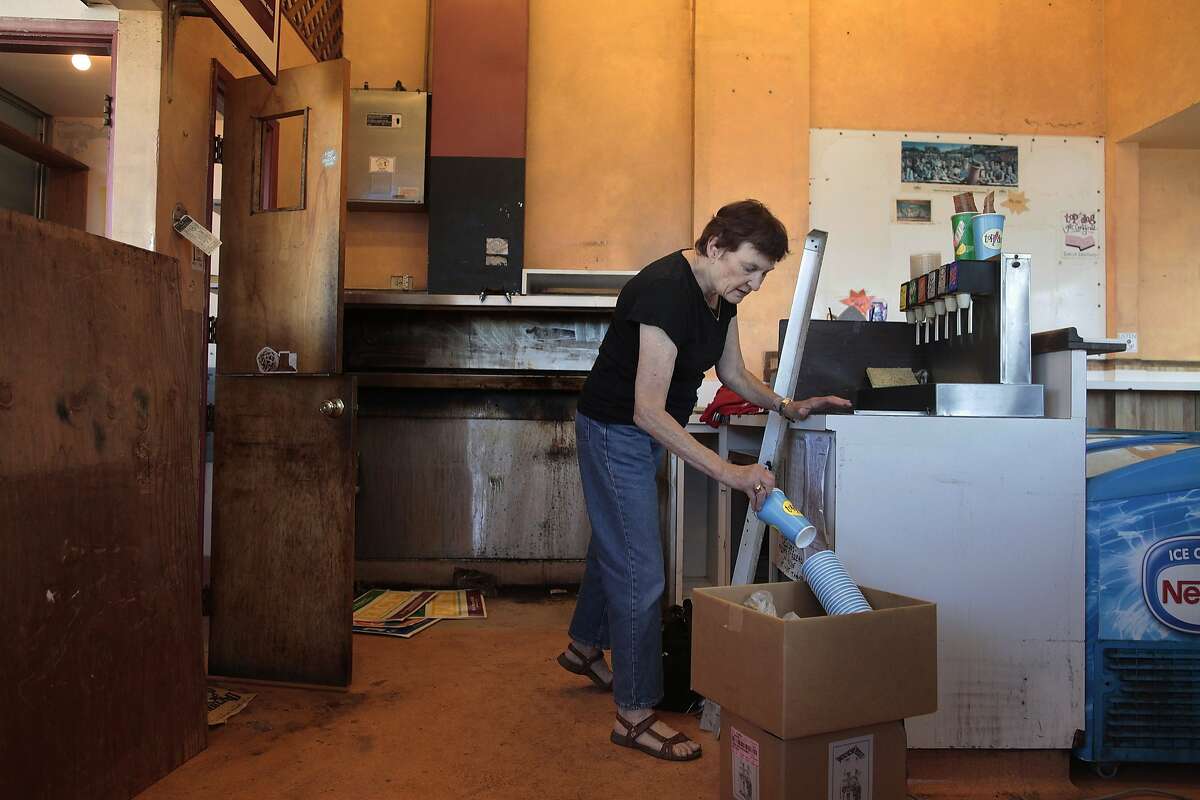 Renie Riemann packs up Top Dog which is slated to close along with CVs in Oakland, Calif. on Friday, June 13, 2014. The CVS, which was previously a Payless, was a place where you could buy a hot dog, repair your shoes and buy household items in one stop.
