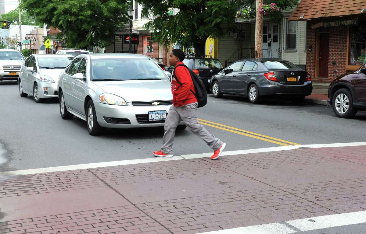 A person uses the crosswalk to cross Delaware Avenue at the intersection of Bertha Street on Friday afternoon, June 13, 2014, in Albany, N.Y. (Michael P. Farrell/Times Union)
