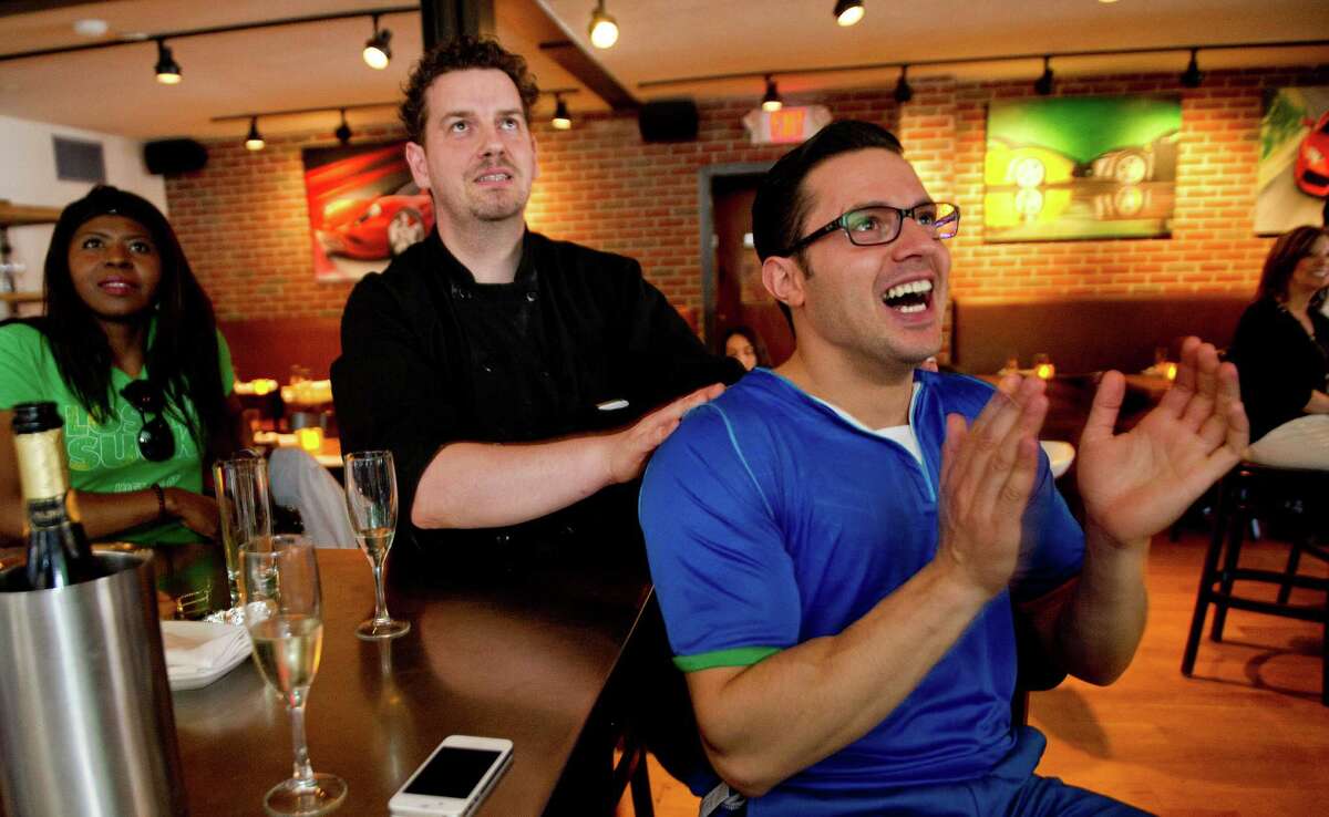 Bar Rosso chef Massimo Stecchi, left, and manager Andrea Lombardi, right, watch watch the Italy vs. England World Cup game at the Stamford, Conn., restaurant on Saturday, June 14, 2014.