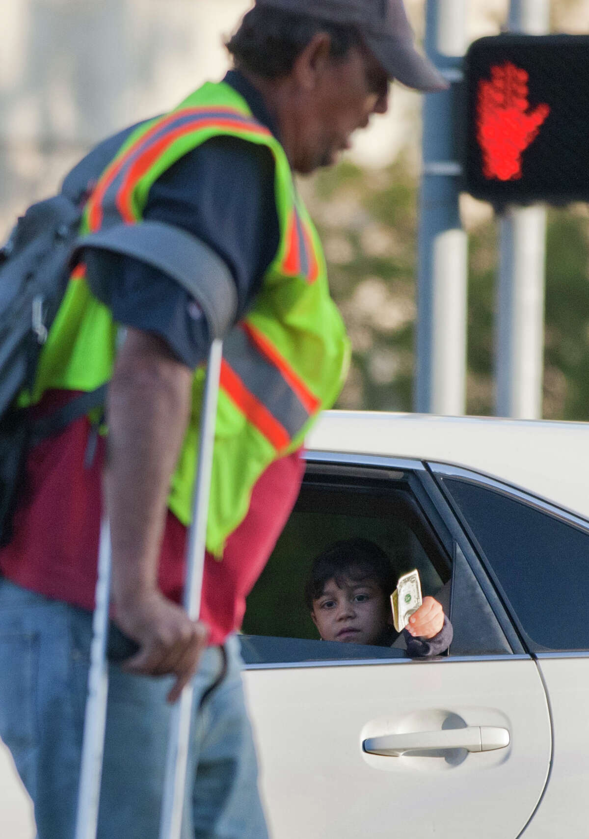 Heading for his regular panhandling spot and not yet paying attention, Carbonneau misses out on a few dollars from a passing car on Woodway at the Loop.