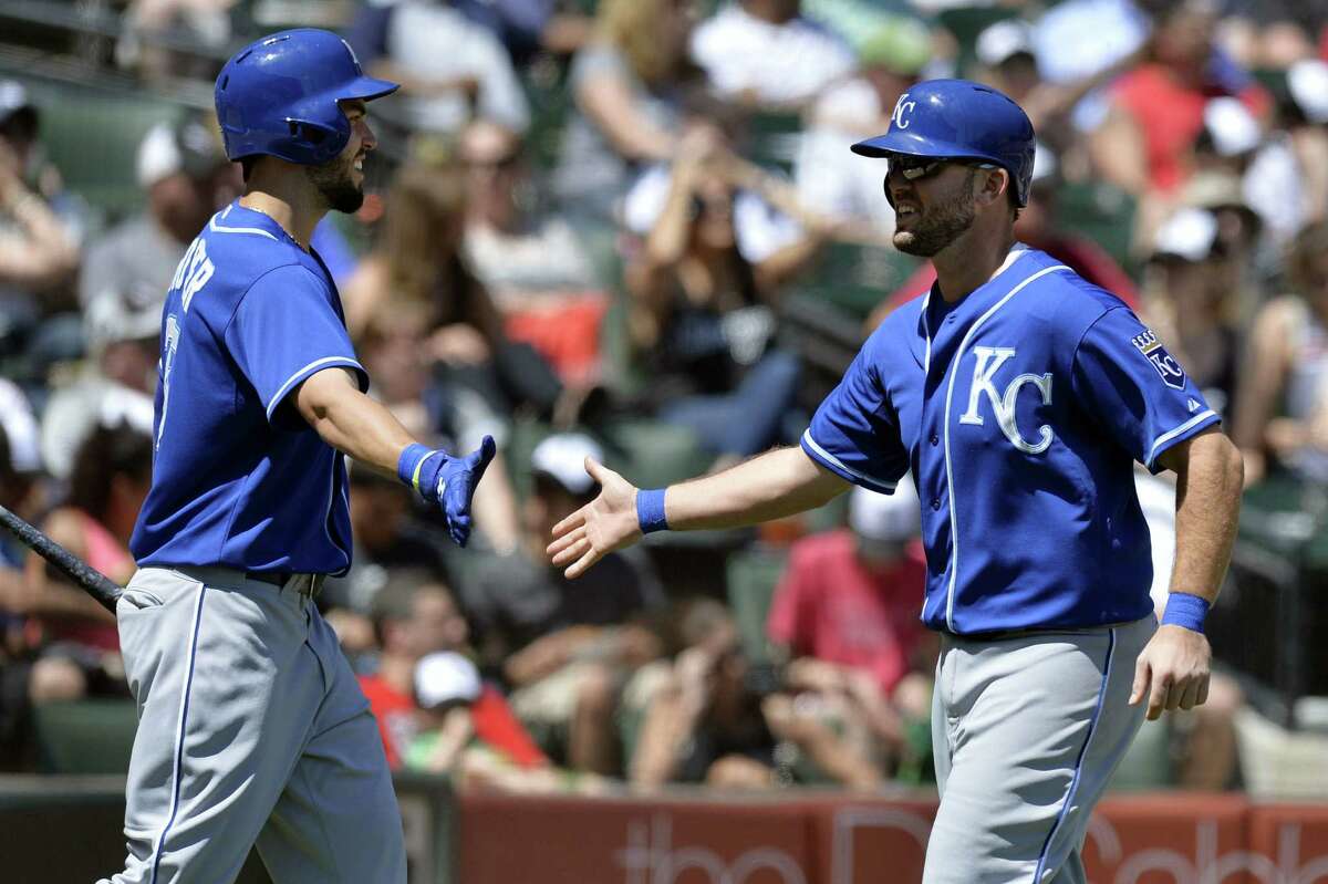 Eric Hosmer (left) congratulates Mike Moustakas, who finished with a homer among his three hits.