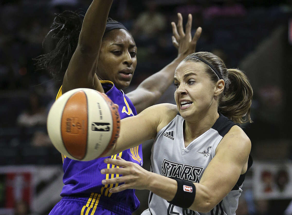 Stars point guard Becky Hammon, who had 10 points and four assists, passes around Los Angeles' Nneka Ogwumike.