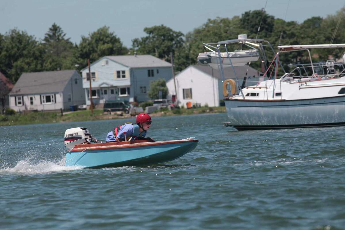 Aquaculture students race boats they made