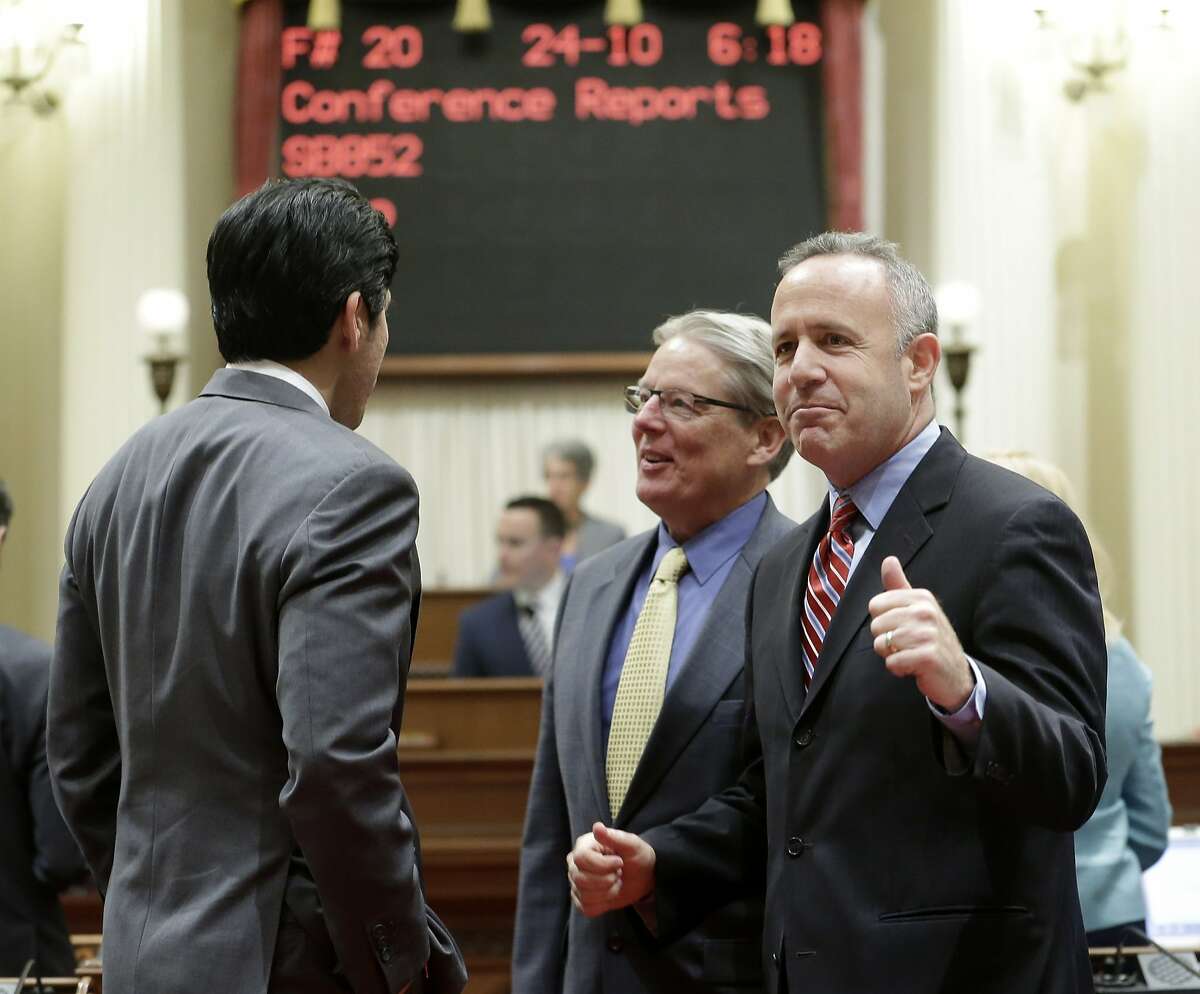 State Senate President Pro Tem Darrell Steinberg, D-Sacramento, right, pumps his fist after the Senate approved the state budget at the Capitol in Sacramento, Calif., Sunday, June 15, 2014. Lawmakers faced a Sunday deadline to pass the $108 billion spending plan that meets Gov. Jerry Brown's demand for a rainy day fund and paying down debt while allocating some of the surplus to programs benefiting lower-income Californians.(AP Photo/Rich Pedroncelli)