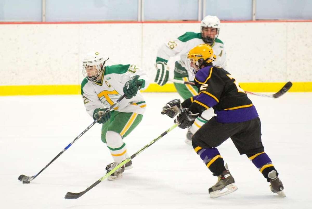 Trinity's Chris Lambrinakos, left, and Westhill's Tyler Rich, right, during an FCIAC boys hockey game at Terry Conners Rink in Stamford, Conn. on Monday, Feb. 15, 2010.