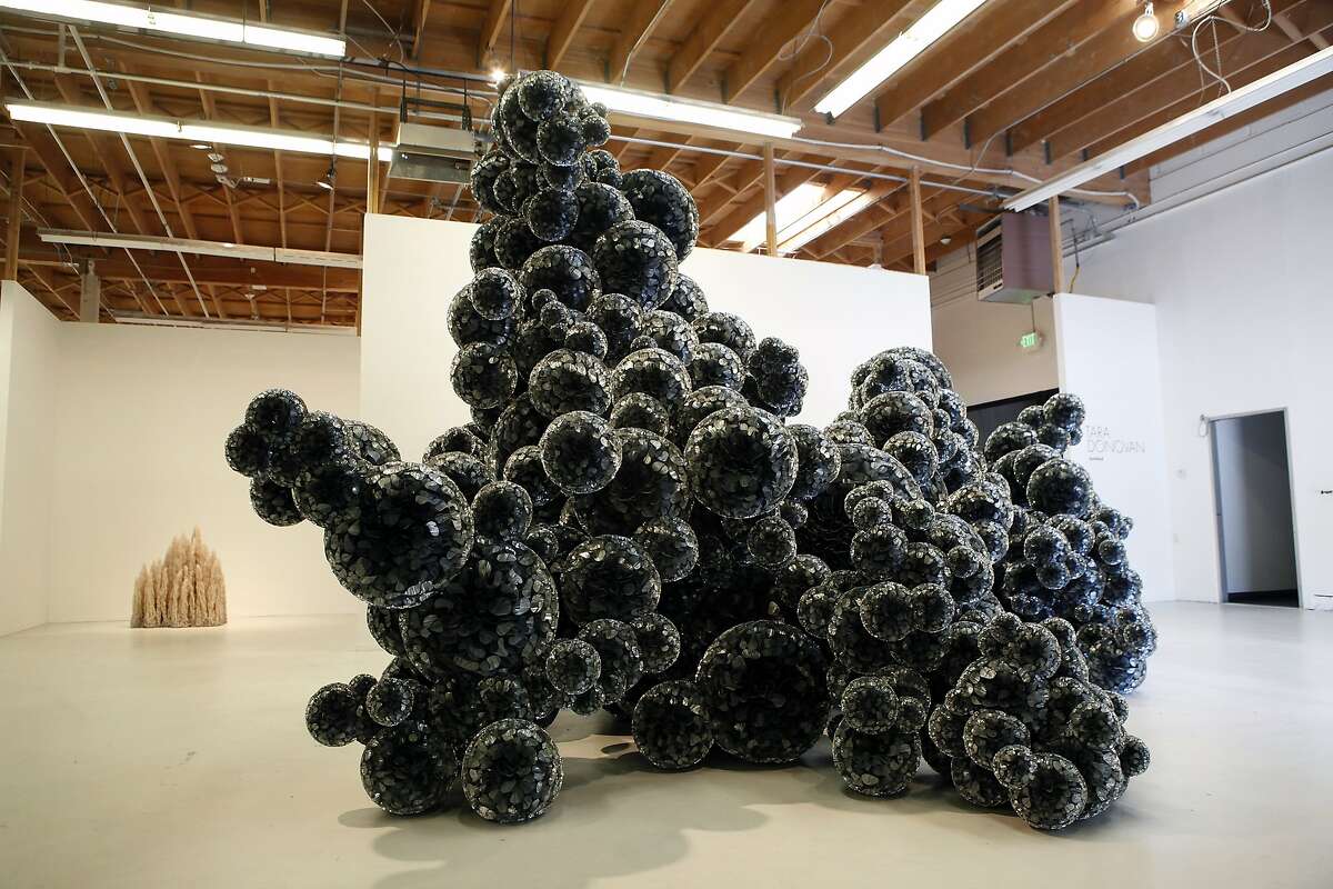 A large untitled piece made of folded mylar sheets glued together by artist Tara Donovan fills the entrance way at the Pace Gallery pop-up space in Menlo Park, CA, Thursday June 12, 2014.