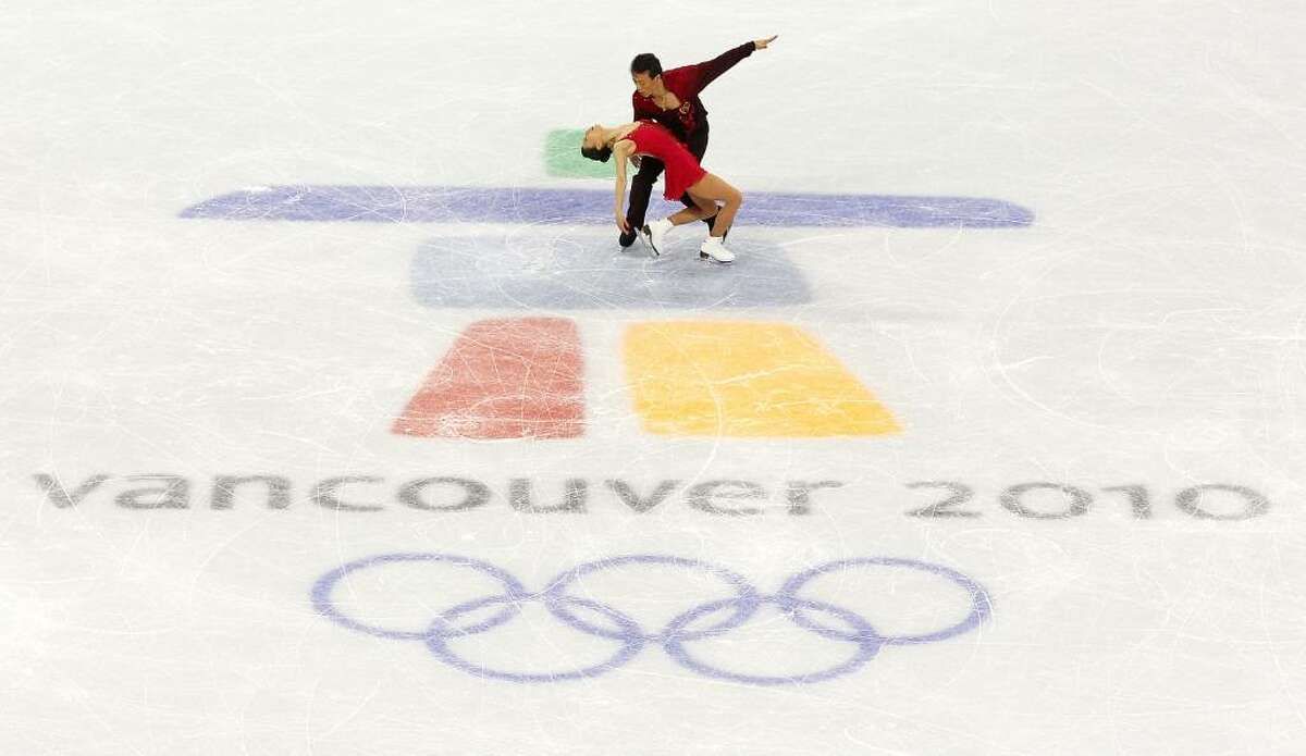 VANCOUVER, BC - FEBRUARY 15: Xue Shen and Hongbo Zhao of China compete in the Figure Skating Pairs Free Program on day 4 of the Vancouver 2010 Winter Olympics at the Pacific Coliseum on February 15, 2010 in Vancouver, Canada. (Photo by Cameron Spencer/Getty Images) *** Local Caption *** Xue Shen;Hongbo Zhao