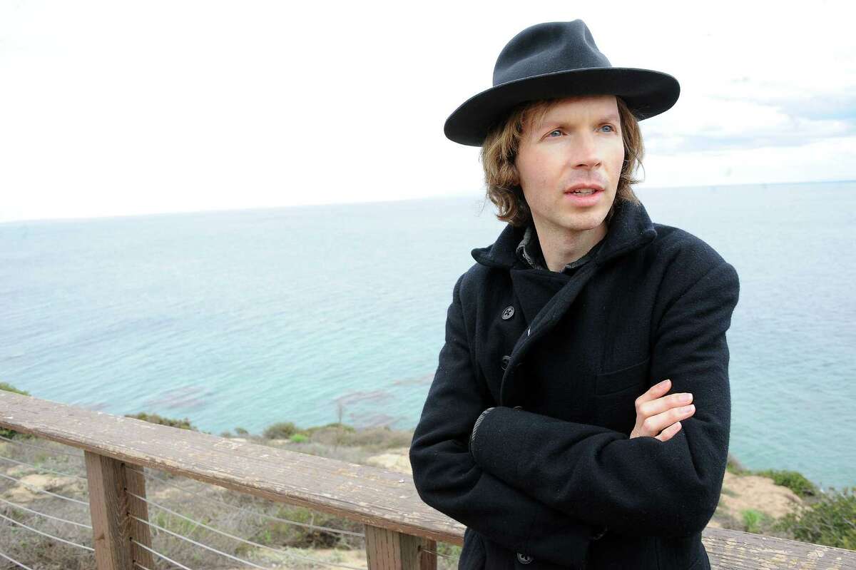 Musician Beck poses for a portrait at his home on Friday, Dec. 14, 2012, in Malibu, Calif. Beck Hansen wants you to think about the way music has changed over the last century and what that means about how human beings engage each other these days. Laboring over the intricate and ornate details of his new "Song Reader" sheet music project, he was struck by how social music used to be something we've lost in the age of ear buds. (Photo by Katy Winn/Invision/AP) ORG XMIT: MER2014061716183877
