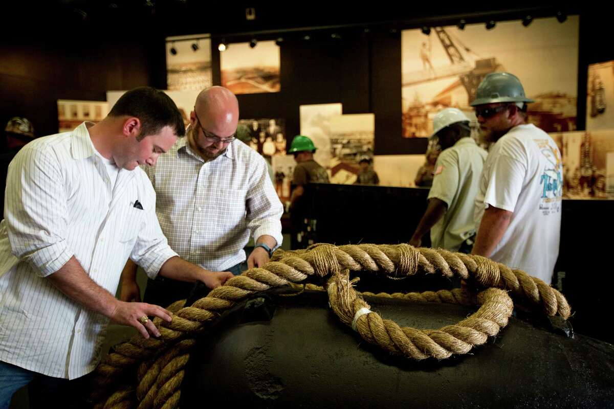 Justin Parkoff, left, and Andrew Thomson, take a look at a Civil War era cannon recovered from the USS Westfield, which sank in the Battle of Galveston in 1863. The cannon was transported from the Texas A&M Conservation Research Lab to the Texas City Museum where it will be exhibited. Wednesday, June 18, 2014, in Texas City.