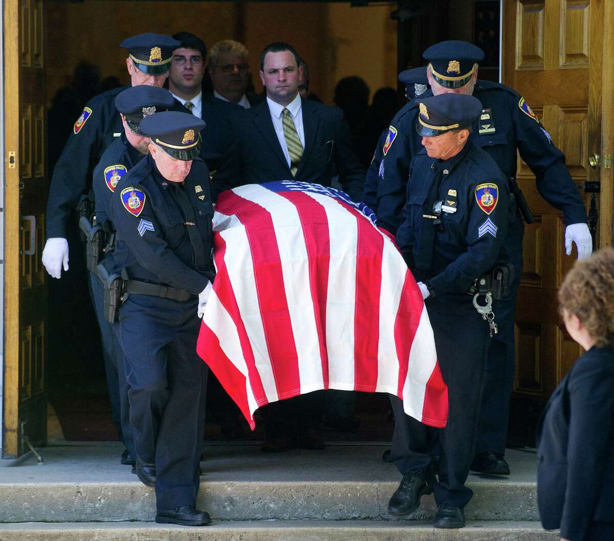 Members of the Stamford Police Department serve as pallbearers for the funeral of former Police Chief Louis DeCarlo at Sacred Heart Roman Catholic Church in Stamford, Conn., on Wednesday, June 18, 2014. Pallbearers were, clockwise from left, Sgt. Anthony Lupinacci, Officer Ed Rondano, Cpt. Gregory Tomlin, Officer Cory Casserta, Sgt. Peter di Spania, and Sgt. Paul Guzda.