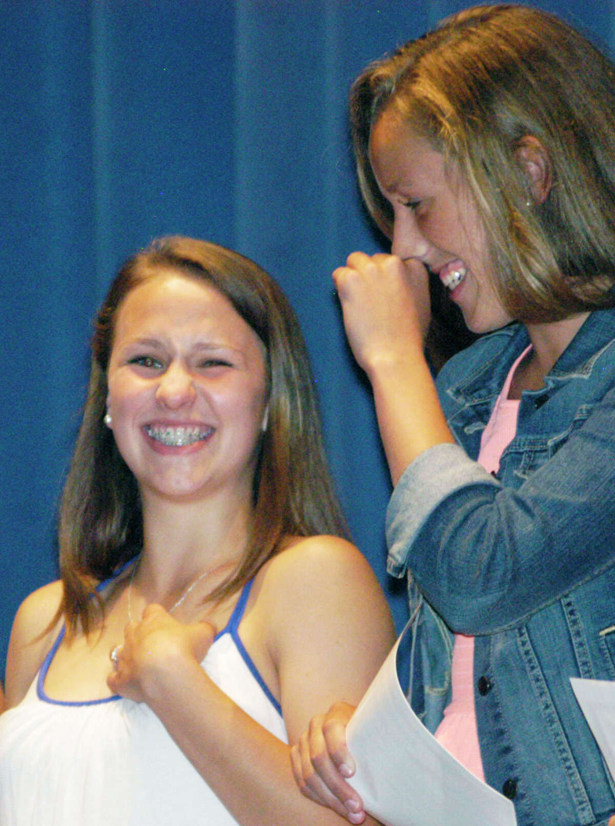 Good friends, asawell as soccer and basketball teammates, Samantha Moravsky, left, and Caroline Kelly share a light moment during Shepaug Valley High School's annual athletic awards ceremony, June 6, 2014 at the school in Washington.