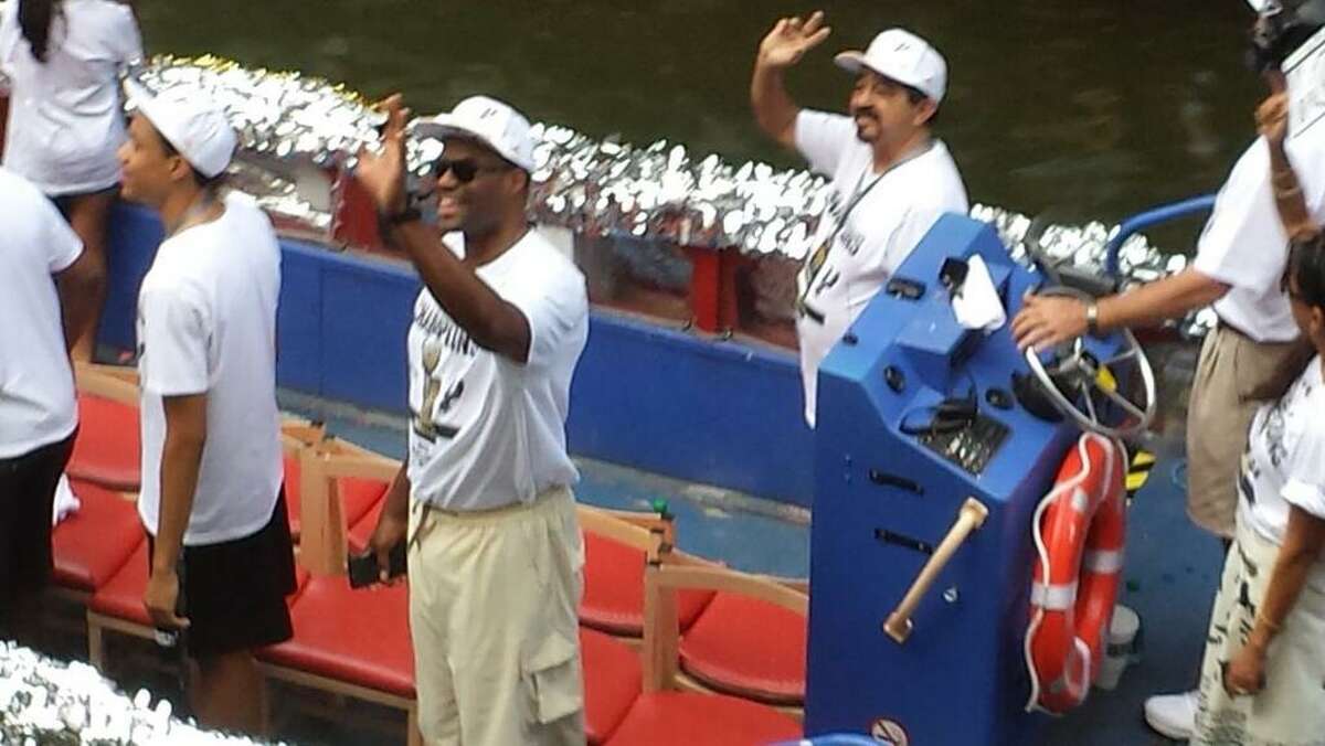 David Robinson waves to the crowd during the Spurs victory parade on the San Antonio River on Wednesday, June 18, 2014.