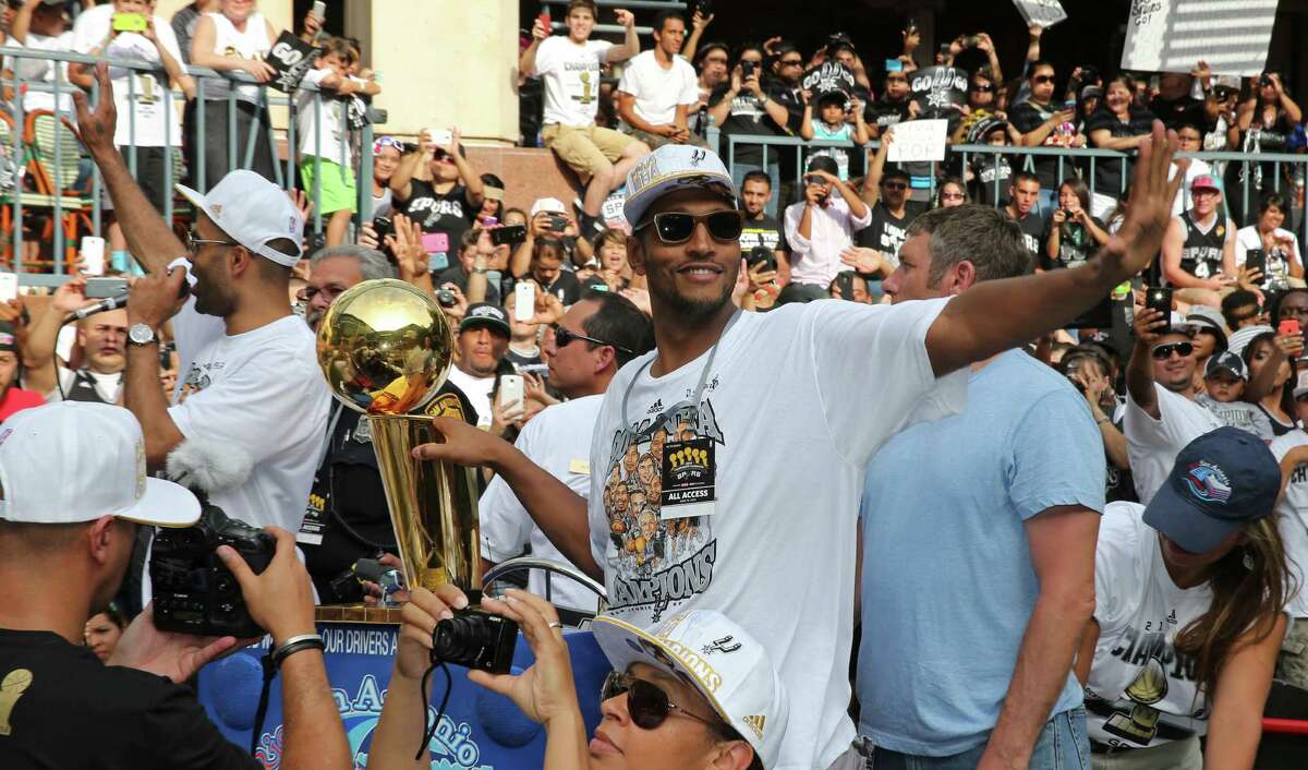San Antonio Spurs' Tony Parker (left) and Boris Diaw take part in the river parade, Wednesday June 18, 2014, for the Spurs after the team captured their fifth NBA championship.