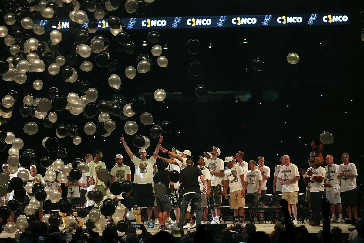 Balloons rain down on the San Antonio Spurs after a team picture with the trophies at the Championship Celebration at the Alamodome, Wednesday, June 18, 2014. The Spurs beat the Miami Heat in the NBA Finals on Sunday to claim the title. The celebration started with a river parade and ended at the Alamodome.