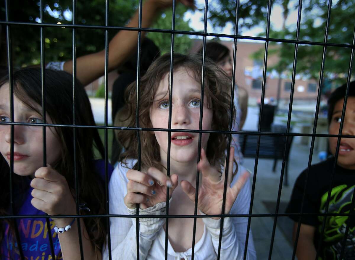 Homeless children, including Alexandra (center), at "The Road Home", a shelter near downtown Salt Lake City, have a fence around their recreation area. They wait for more permanent housing. Salt Lake City, Utah has made great strides in housing and taking care of its homeless population in the last few years.