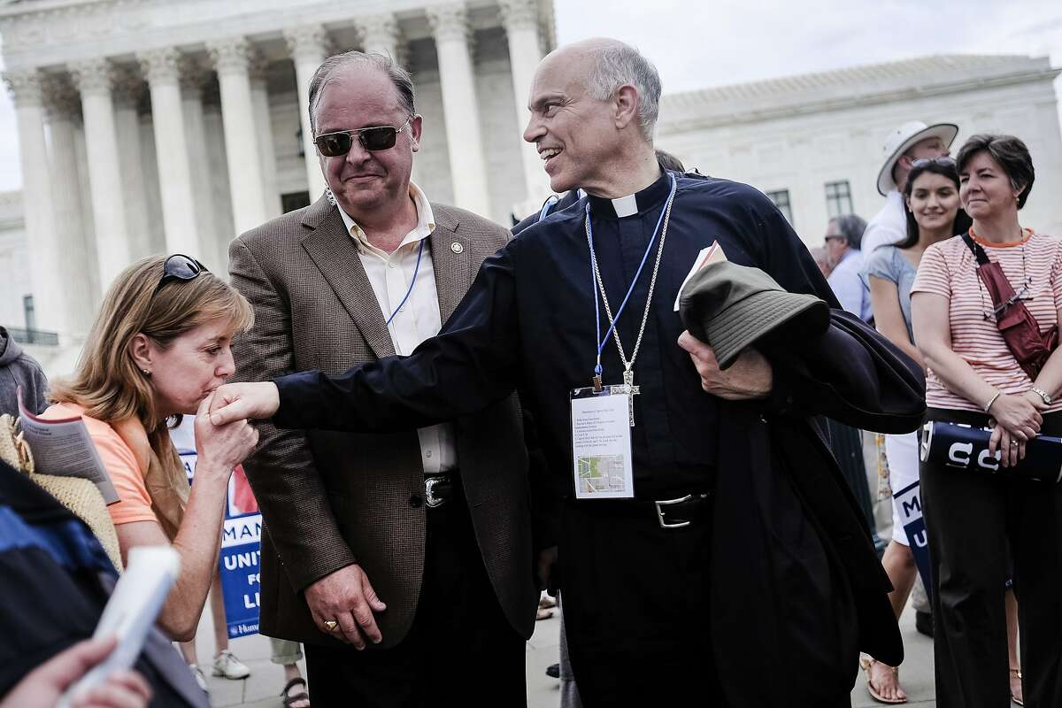 San Francisco Archbishop Salvatore Cordileone is kissed by a supporter as the March for Marriage rally ends outside the Supreme Court in Washington, DC on June 19, 2014. Speakers at the rally and march promoted the definition of marriage as between a man and a woman, and pushed back against the notion that public opinion is heavily in favor of revoking restrictions against gay marriage. (Photo by T.J. Kirkpatrick/Special to The Chronicle)