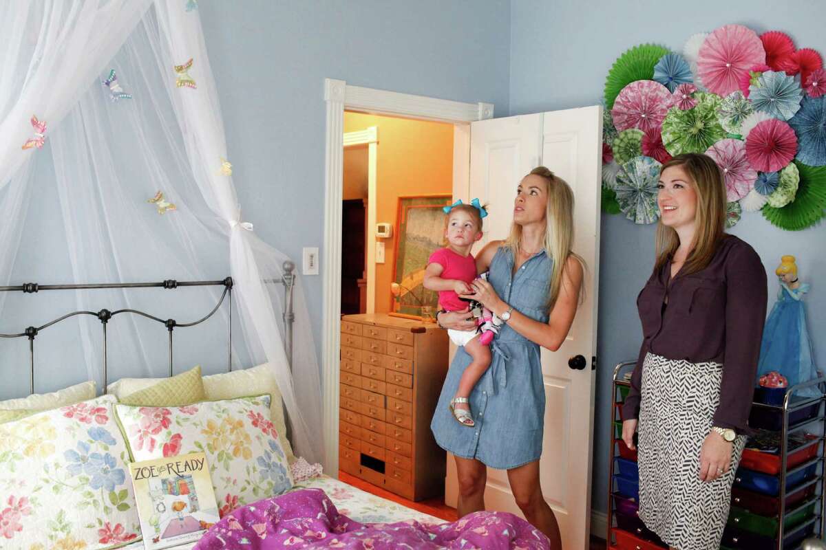 Stephanie Finch, right, of Martha Turner Southeby's International Realty shows a house in the Heights to Casey Scott and her daughter Lyla, 1, June 4, 2014 in Houston. (Eric Kayne/For the Chronicle)