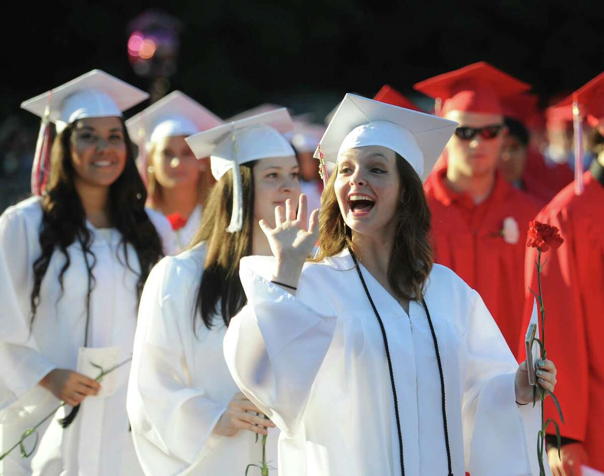 Kendall Polverari waves to the crowd during the Masuk High School 2014 Graduation Ceremony at Masuk High School in Monroe, Conn. Thursday, June 19, 2014.