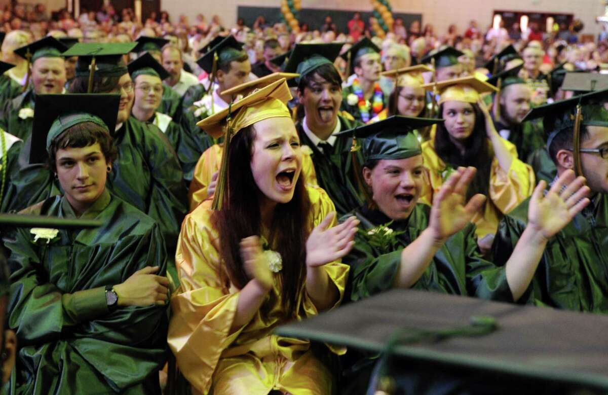 Graduate Lindsay Nicholson, of Naugatuck, sings along to "Time of Your Life," by Green Day during the Emmett O'Brien Technical High School commencement ceremony Thursday, June 19, 2014 at the school in Ansonia, Conn.