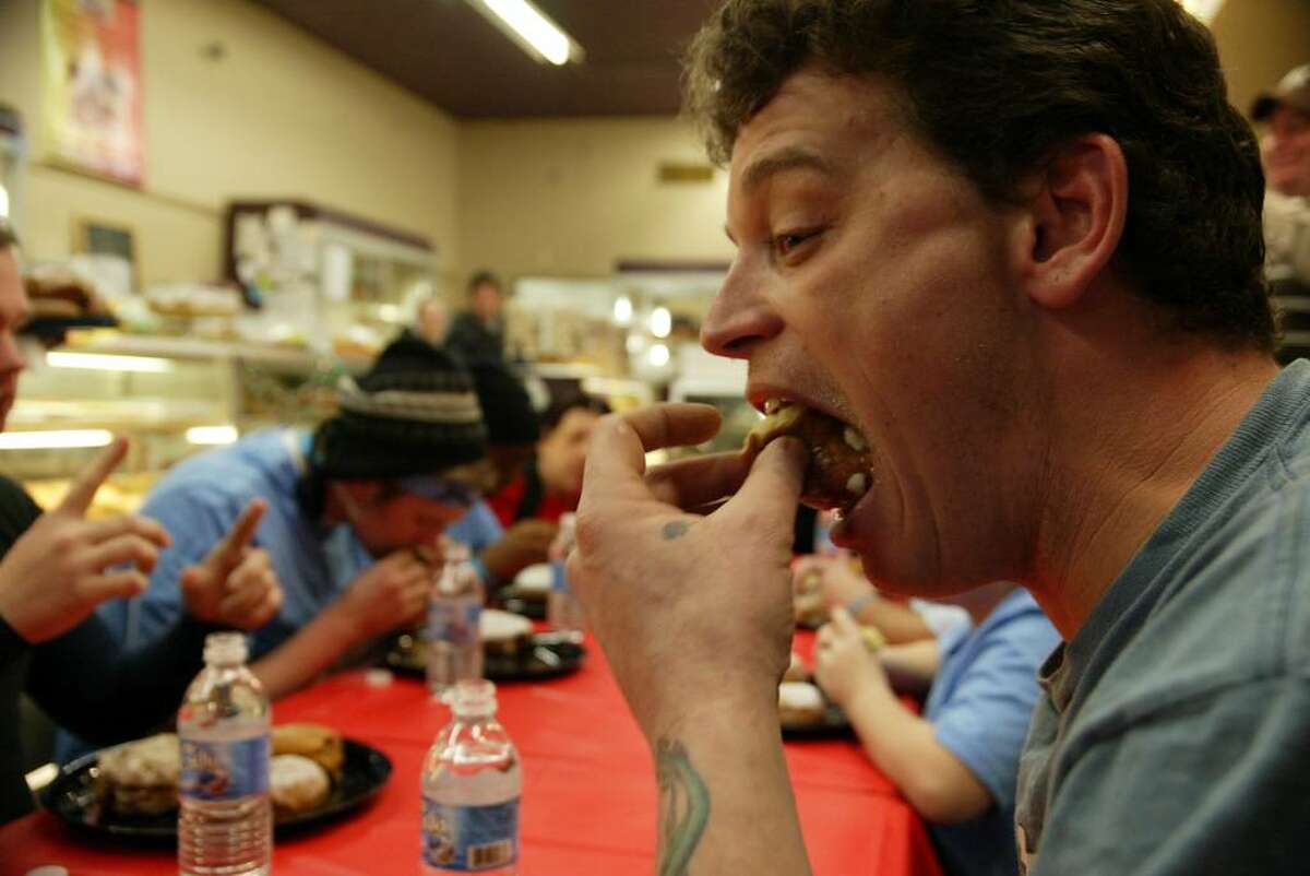 Ansonia resident, Mike Crockett bites into one of the five Paczki's he ate, Tuesday, Feb. 16, 2010. Crockett took part in the annual Paczki Eating Contest at Eddy's Bake Shop in Ansonia.
