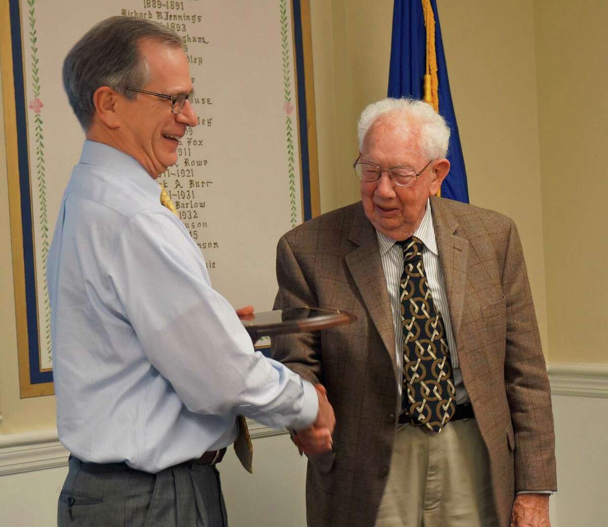 Conservation Commission Chairman Kevin Gumpper presents Frank Rice with a plaque honoring his 15 years on the panel.