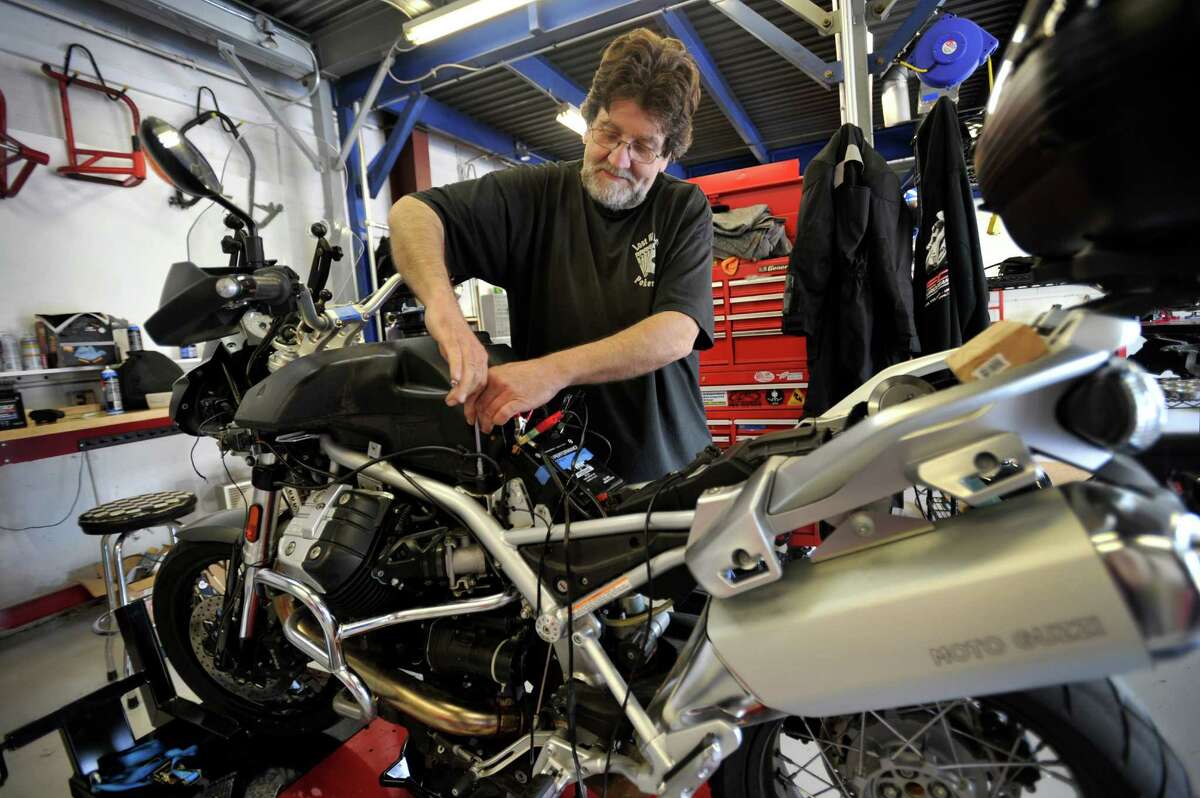 Mechanic Jeff Ciurek, 59, of Redding, Conn.works on a Moto Guzzi Stelvio motorcycle at of Hamlin Cycles, 44 Grassy Plain Rd. in Bethel, Conn., Friday, June 20, 2014.