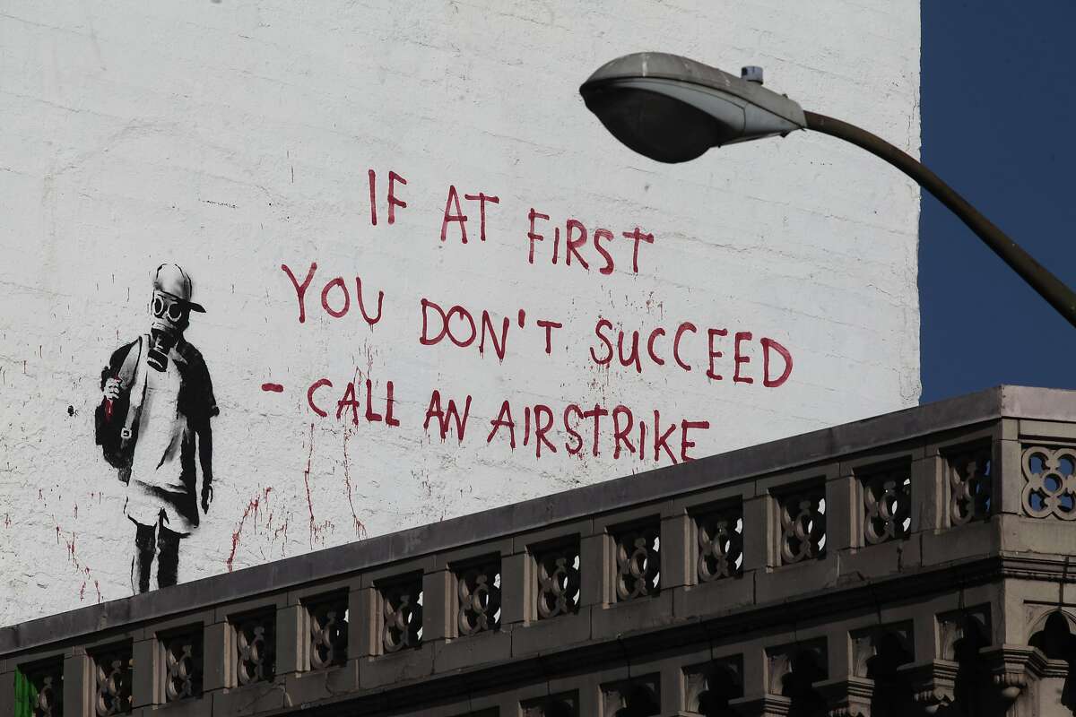 A banksy piece looms over the corner of Columbus Ave. and Broadway St. in San Francisco, Calif. on Thursday, June 19, 2014. San Francisco is home to several Banksy pieces.