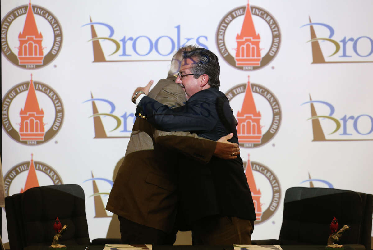 University of Incarnate Word President Lou Agnese, left, and Brooks City Base President and CEO Leo Gomez hug after signing a Memorandum of Understanding to house the university's School of Osteopathic Medicine at Brooks, Tuesday, June 10, 2014. The school will be located in "The Hill," a registered historical area that once housed the U.S. Air Force School of Aerospace Medicine. The school is scheduled to open in 2016.