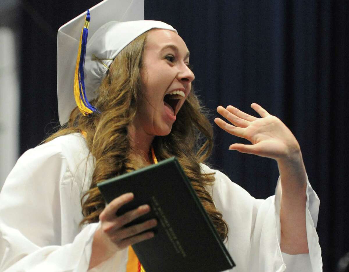 Jaclyn Mercer waves excitedly after receiving her diploma at the New Milford High School 2014 Graduation Ceremony at Western Connecticut State University's O'Neill Center in Danbury, Conn. Saturday, June 21, 2014.