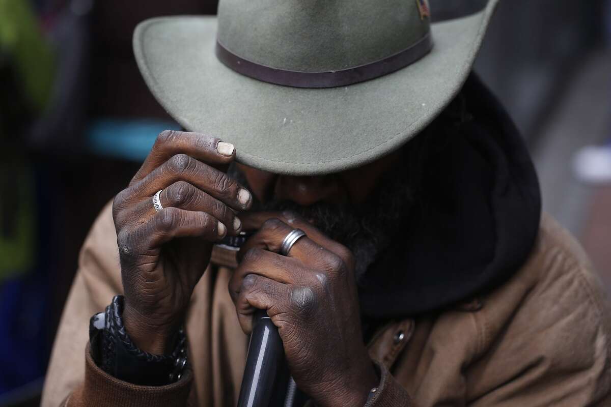 Delta blues harp player gets by with captive audience