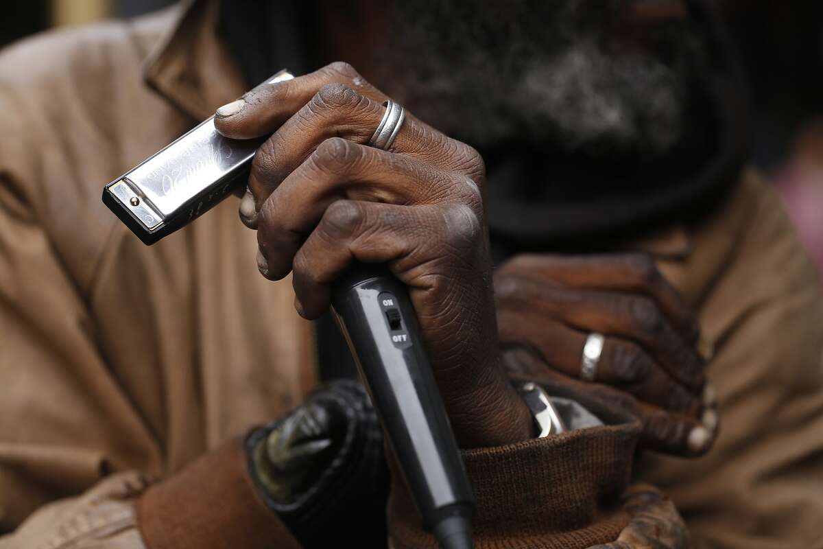 Delta blues harp player gets by with captive audience