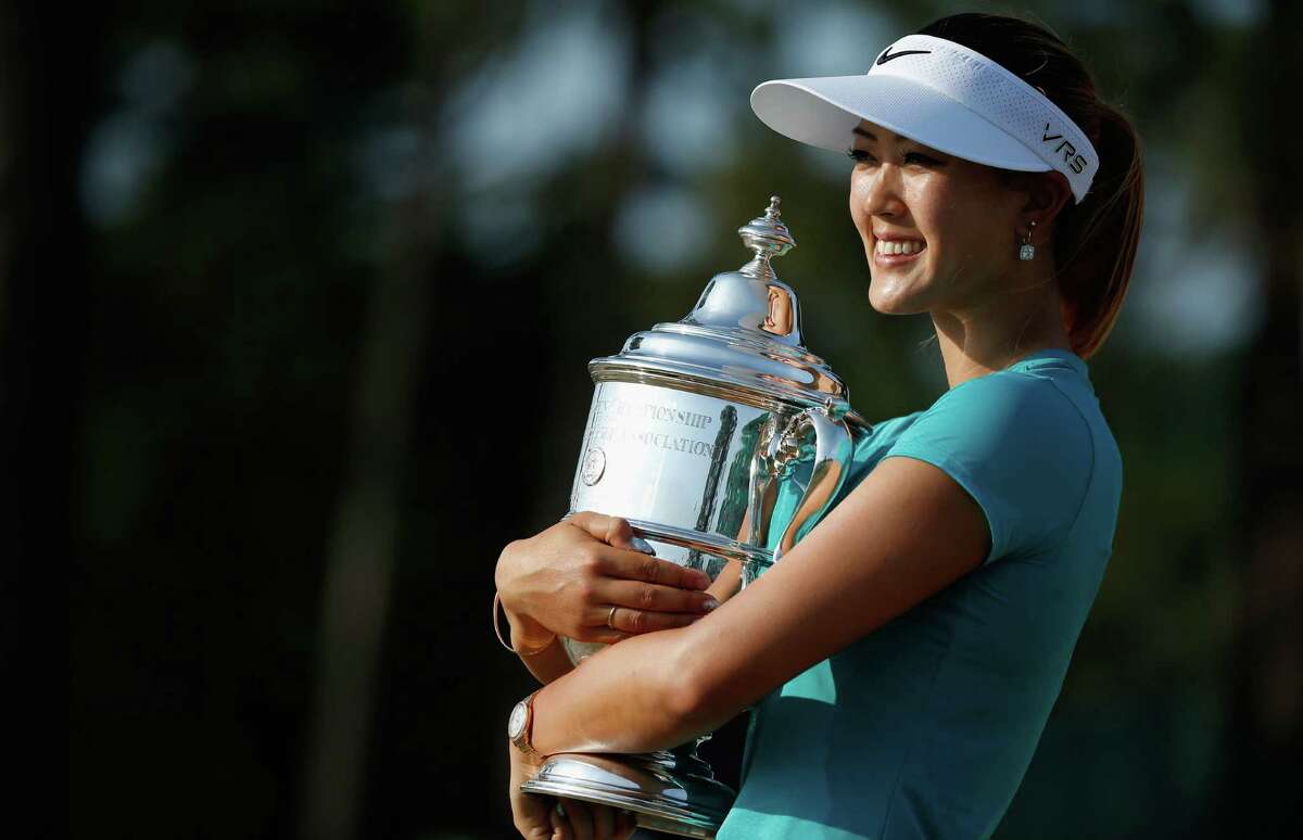 Michelle Wie poses with the U.S. Women's Open trophy after her two-shot victory over Stacy Lewis on Sunday at Pinehurst No. 2.