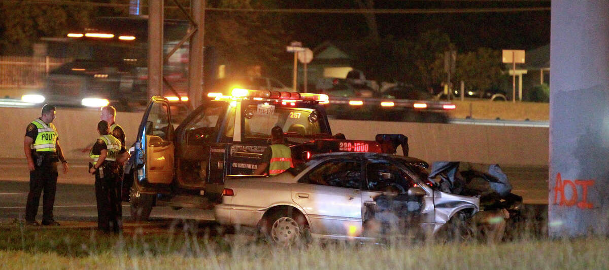 San Antonio police investigate the scene of a fatal car crash that took place about 3:30 a.m. Monday, June 23, 2014, on northbound U.S. 281 near Nakoma. According to local television reports, police said the driver of the vehicle slammed into a concrete pillar and the car caught fire. Northbound 281 was reduced to one lane of traffic while the accident was being cleared.