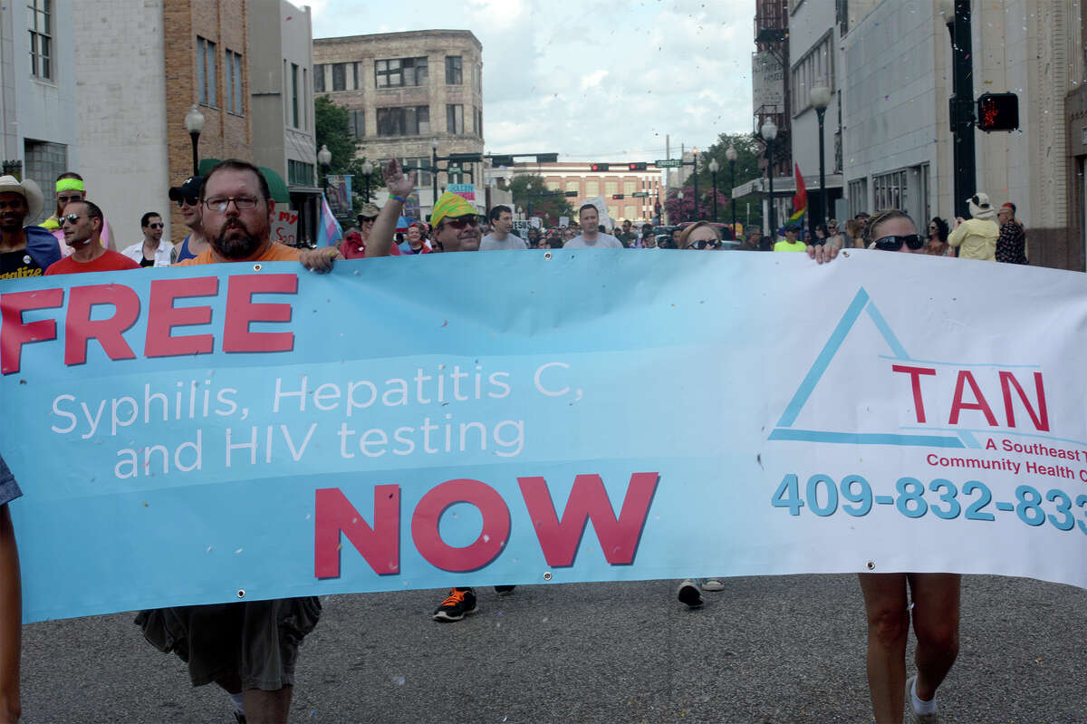 Supporters hold signs while walking along Orleans Street during Beaumont's first Pride Parade on Saturday. Photo taken Saturday, June 21, 2014 Guiseppe Barranco/@spotnewsshooter