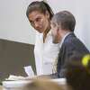 U.S. women's soccer team goalkeeper Hope Solo listens to her attorney Todd Maybrown in Kirkland Municipal Court on Monday, June 23, 2014, in Kirkland, Wash. Solo has entered a not guilty plea following her domestic violence arrest at her sister's home in suburban Seattle.