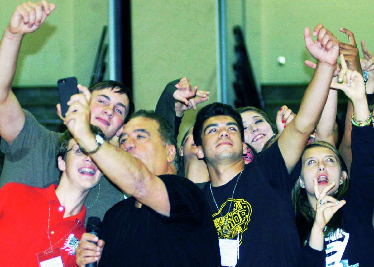 Graduates enjoy creating what could best be described as "air selfies" while participating in hypnotist Dan LaRosa's show during the New Milford High School Grad Party, June 21-22, 2014 at NMHS.
