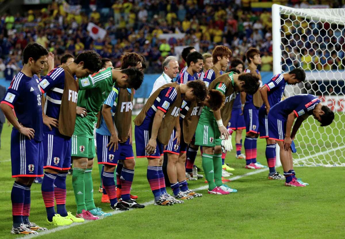 Japan's players salute fans after during the group C World Cup soccer match between Japan and Colombia at the Arena Pantanal in Cuiaba, Brazil, Tuesday, June 24, 2014. Colombia won 4-1.(AP Photo/Dolores Ochoa)