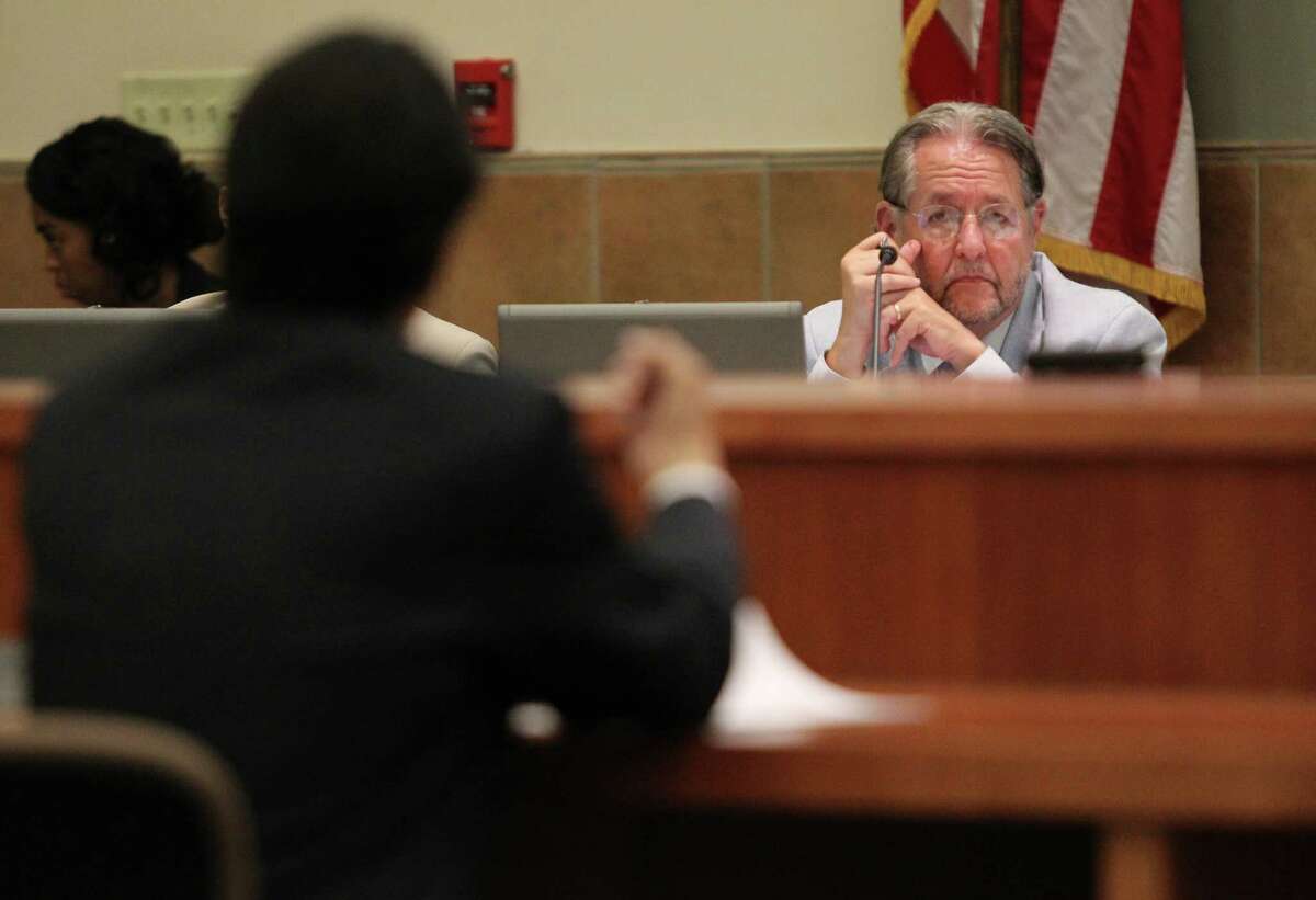VIA Trustee Richard Gambitta listens as George Alejos, a member of the League of United Latin American Citizens, voices his opposition to the downtown streetcar plan during a VIA Board of Trustees meeting on Tuesday, June 24, 2014, at the VIA headquarters in San Antonio.