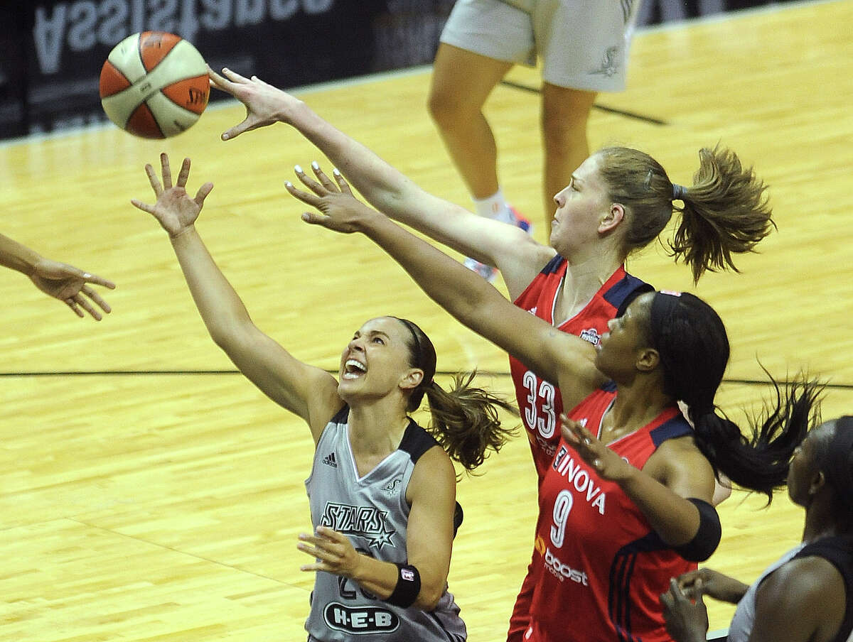 Becky Hammon of the San Antonio Silver Stars shoots a layup as Emma Messerman (33) and Kia Vaughn of the Washington Mystics defend during WNBA action in the Alamodome on Tuesday, June 24, 2014.